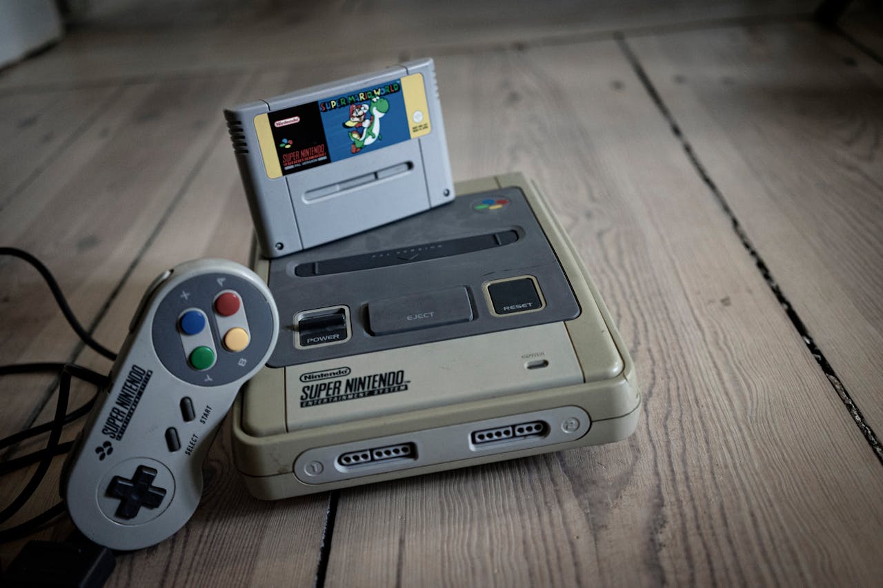 The Art of Drawing Readers In: Your attractive post title goes here From above of aged video game console with cassette and controller with colorful buttons on wooden surface